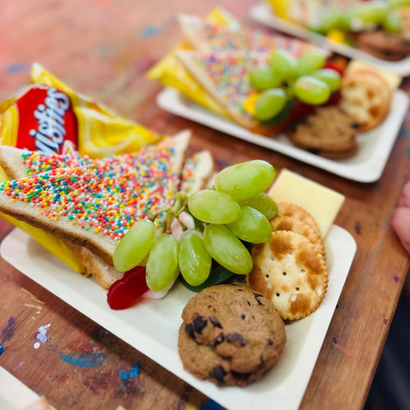 DIY Invasion's catering, snack box with fairy bread, fruits, cookies, cheese, and chips